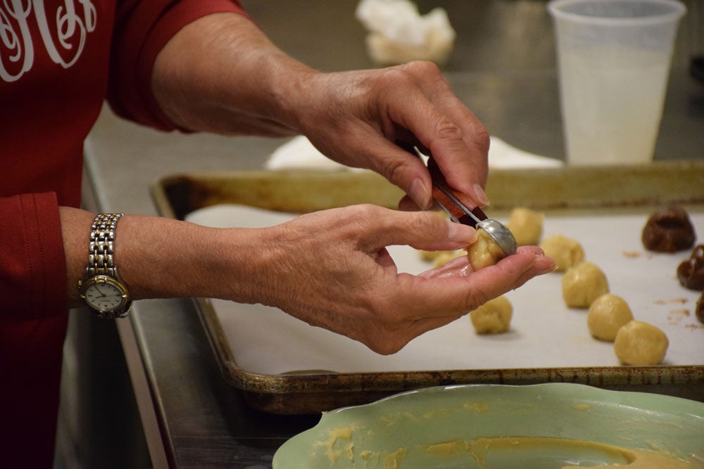 Close-up image of LLP cooking class participant making authentic sausage balls